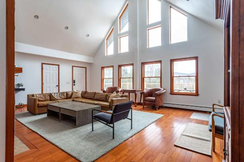 a living room with a couch and a table at Kaaterskill Mountain House - 287 Acres with Fire Pit in Elka Park