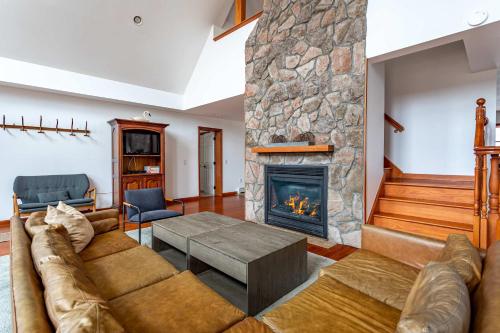a living room with a couch and a fireplace at Kaaterskill Mountain House - 287 Acres with Fire Pit in Elka Park