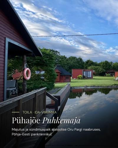 a picture of a house with a pond in front of it at Pühajõe Puhkemaja in Pühajõe