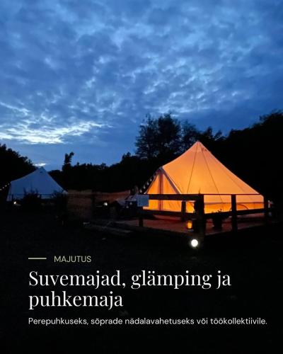 a large tent is lit up at night at Pühajõe Puhkemaja in Pühajõe