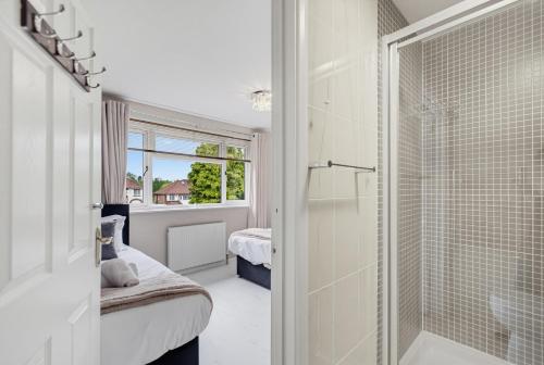 a bathroom with a walk in shower and a walk in shower at Spacious 4BR with Parking for Groups & Contractors in Solihull