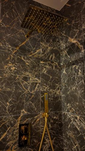 a bathroom with a marble counter top with a glass wall at L'Écrin d'Or - Spa - Cinéma privé in Saumur
