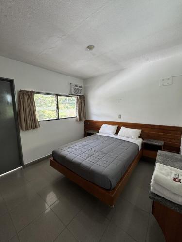 a bedroom with a bed and a window at Hotel Harmony in Caracas