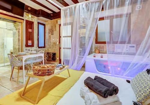 a living room with a table and a tub at Bed & Spa - La Parenthese in Dijon
