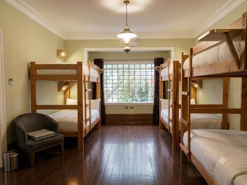 a room with four bunk beds and a window at Eco Inn in Cusco