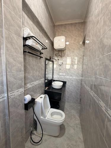 a bathroom with a white toilet and a sink at Njiro Luxury in Arusha