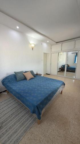 a bedroom with a large blue bed in a room at Dar Sidi Mohamed in Zarzis