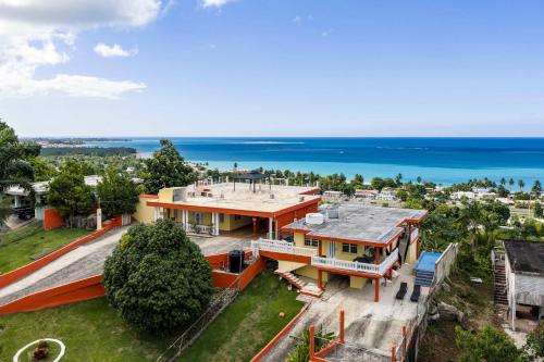 an aerial view of a house with the ocean in the background at 2 Ocean View Villas with Private Pool in Luquillo