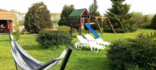 a swing set and a playground with a slide at Apartmani Ćosić in Kuršumlija