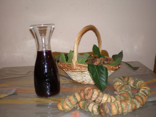 a table with a basket and a bottle and a basket of nuts at Apartments Anita Frane in Vodice