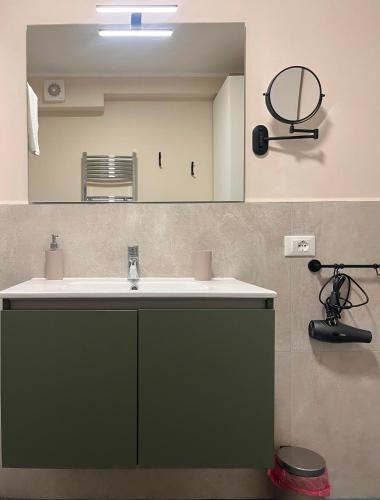 a bathroom with a sink and a mirror at Caraceni Apartaments 2 in Castel di Sangro