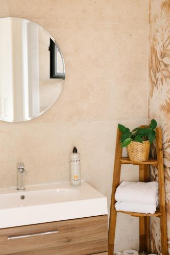a bathroom with a sink and a mirror at Villa Kokona Private Pool Sea View in Sophtadhes