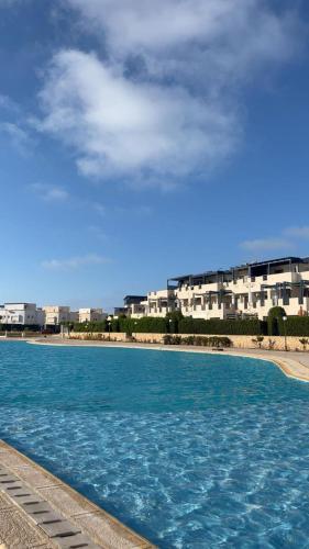 a large pool of water in front of a building at Remas resort in El Alamein
