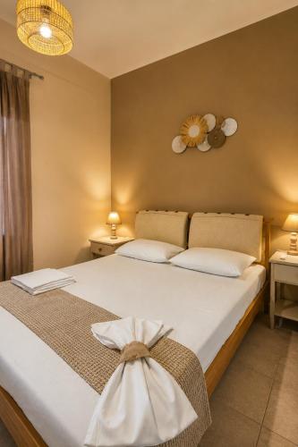 a bedroom with a large bed with a bow on it at Camvas Apartments in Panormos Kalymnos