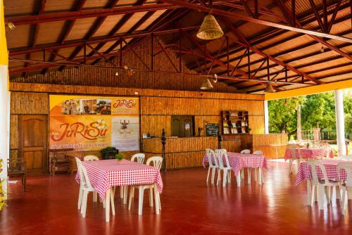 a restaurant with pink and white tables and chairs at Jurisu Resort in San Vicente
