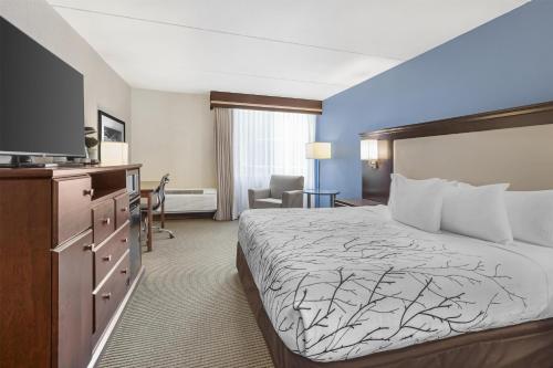 a hotel room with a bed and a flat screen tv at Best Western Plus Coeur d'Alene Inn in Coeur d'Alene