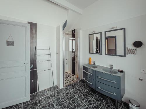 a bathroom with a sink and a mirror at La Source de la Scance in Verdun-sur-Meuse