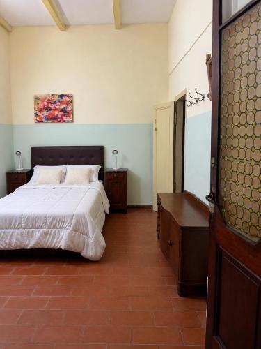 a bedroom with a bed and a dresser in it at Hotel Histórico San Telmo in Buenos Aires