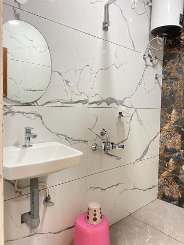 a bathroom with a sink and a mirror at Hotel PR Royal in Bhīmavaram