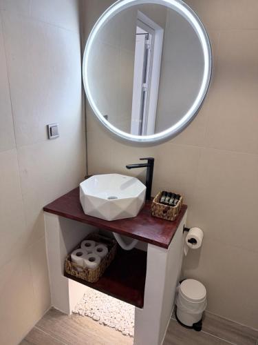 a bathroom with a sink and a mirror at Kanal Vstay #1 in Kithnos