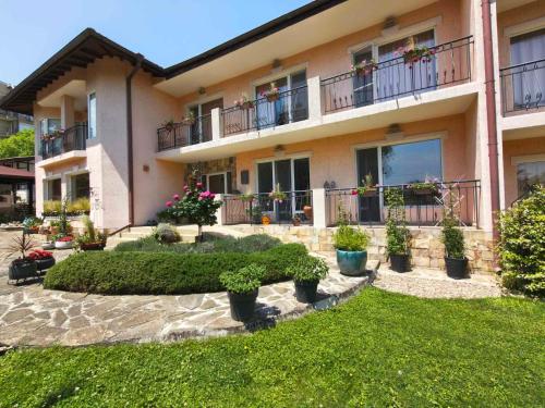a house with plants in front of it at Motivi Hotel in Saints Constantine and Helena