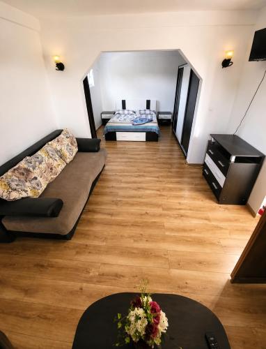 a room with two beds and a couch and a table at Vila Dana in Costinesti
