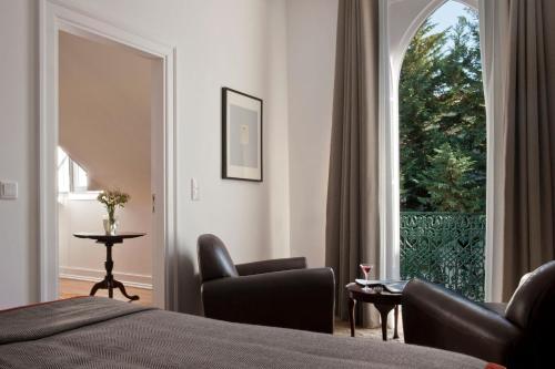 a bedroom with a bed and a large window at Casa Balthazar in Lisbon