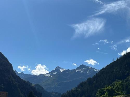 a view of a mountain range with snow capped mountains at pensione VAIS in Piotta