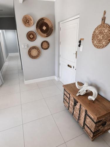 a room with a table and plates on the wall at Pet-Friendly, 3-Bed, 2-Bath in Knysna Central in Knysna