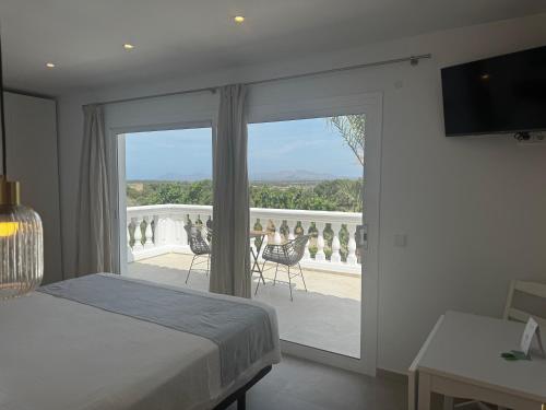 a bedroom with a bed and a view of a balcony at Son Flor Agroturisme in Santa Margalida