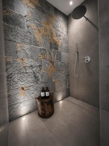 a bathroom with two bottles of wine sitting on a stump at Petra Maris B&B in Peschici