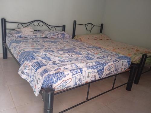 a bed with a quilt on it in a room at Casa Hotel el Sueño in Villavieja