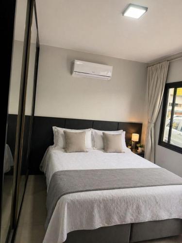a bedroom with a large bed with white pillows at Pousada Rancho do Sossego in Céu Azul