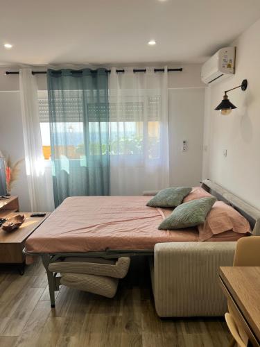 a bedroom with a bed and a window at Charmant studio île & cap in Bastia
