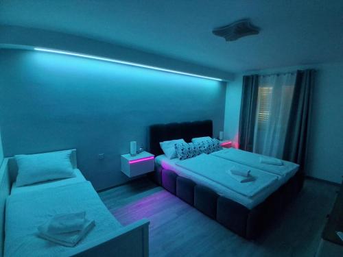 a blue room with two beds and a couch at Apartment Matija in Stara Novalja