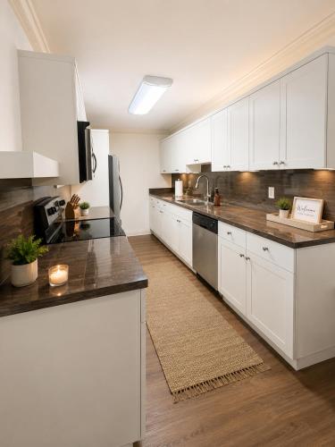 a kitchen with white cabinets and a counter top at Santorini Shores in Biscayne Park