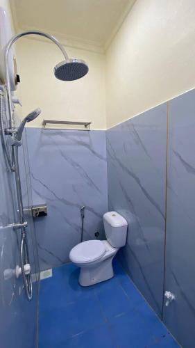 a blue bathroom with a toilet and a shower at EcoWave Retreat- Muli in Muli