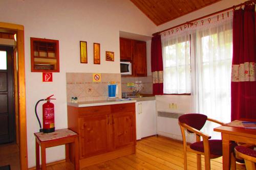 a kitchen with a sink and a table with a table sidx sidx sidx at Chata u vinára Milana, Tatralandia in Liptovský Mikuláš