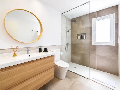 a bathroom with a sink and a toilet and a mirror at Villa Maria 7 in Puerto Calero