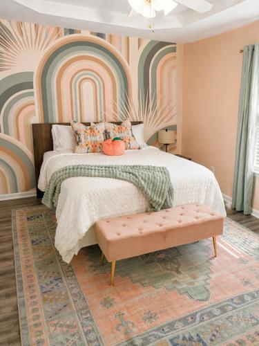 a bedroom with a large bed with a rainbow wall at luxury condo, pet friendly, close to everything in Augusta