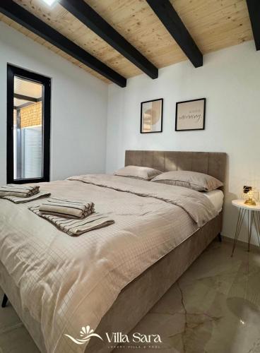a bedroom with a large bed in a room at Villa SARA Bugojno in Bugojno