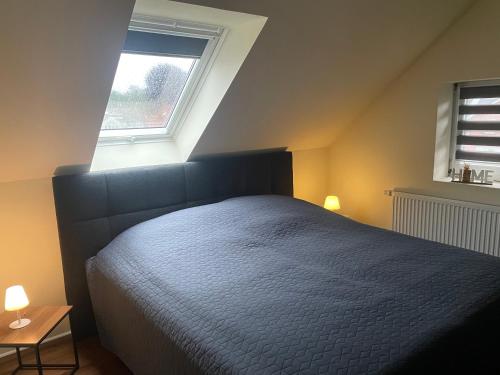a bedroom with a large bed and a window at Apartament am Landgestüt in Warendorf