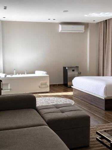 a living room with a bed and a couch at Pyra King Royal Pyramids Hotel in Cairo