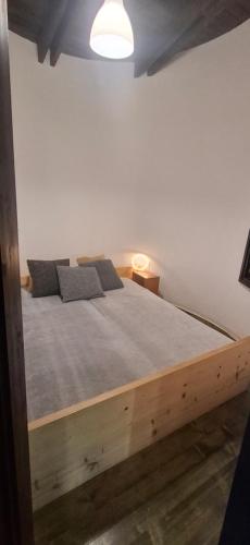 a bedroom with a wooden bed in a room at LAKEview HAUS in Braslovče