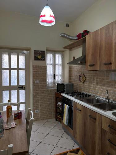 a kitchen with a sink and a stove top oven at IL PARADISO DEGLI DEI 2 in Agerola