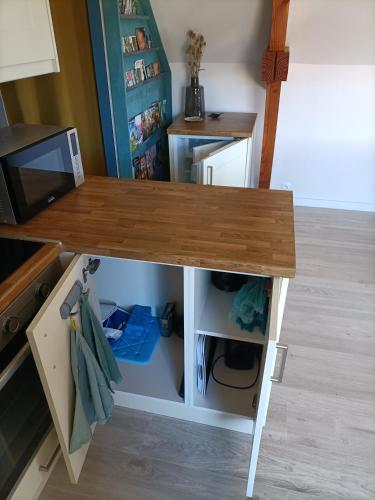 a table in a doll house with a kitchen at Le Petit Manoir Vaillac in Fonmourenne
