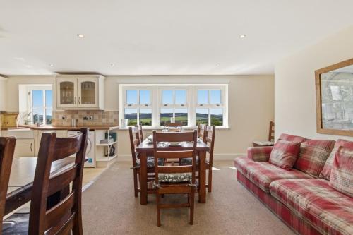a living room with a couch and a table at Ghyllstead - North East Escapes in Glanton