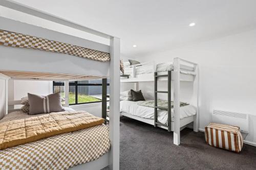a bedroom with two bunk beds and a window at Chic coastal living in Anglesea