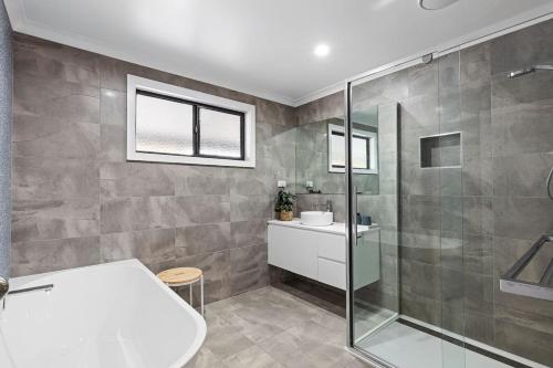 a bathroom with a shower and a toilet and a sink at Chic coastal living in Anglesea