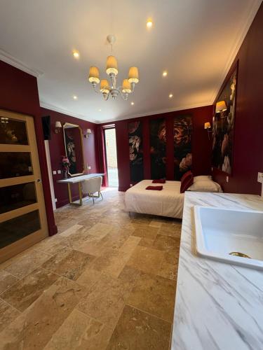 a room with two beds and a bathtub in it at Domaine Des Hêtres in Longraye